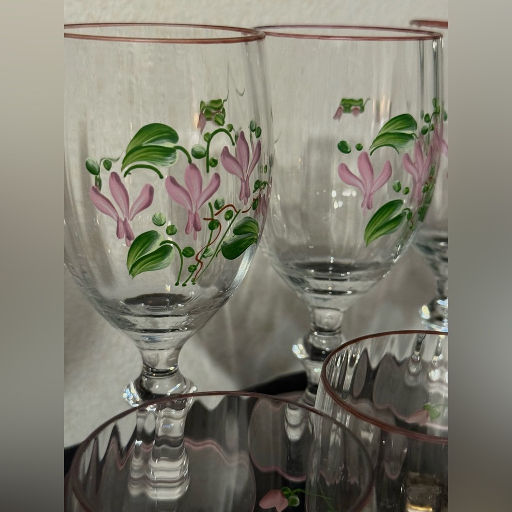 8 hand-painted wine glasses rose gold rims and around the  base.